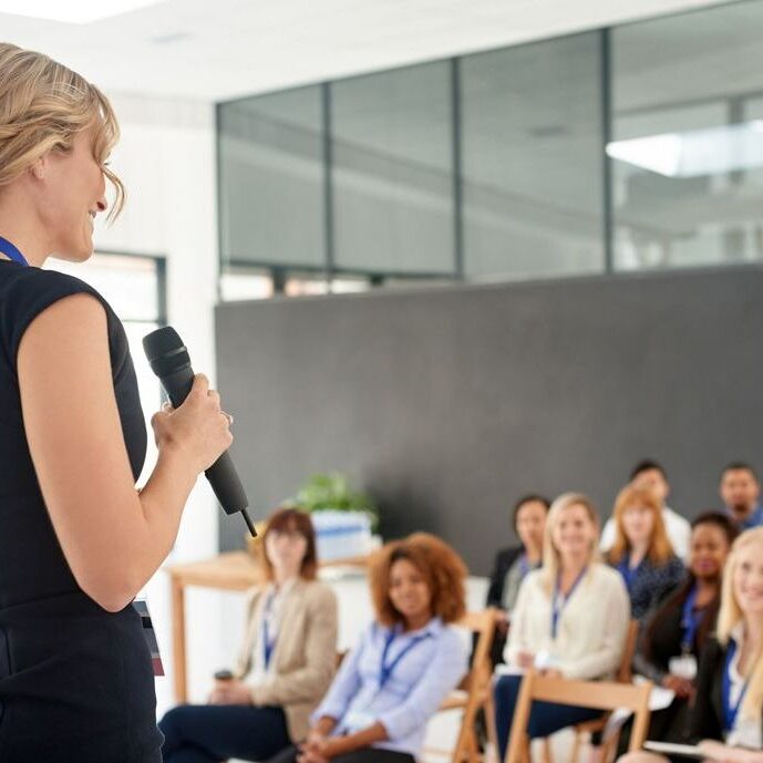 Shot of a young businesswoman delivering a presentation at a conference